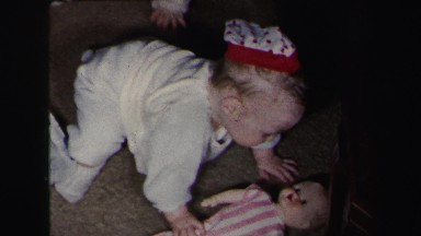 1972: twin babies crawling around on the floor playing with toys LYNBROOK