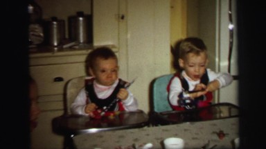 1972: children sitting down and blowing on party horns. LYNBROOK, NEW YORK