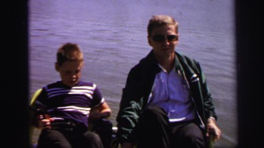 1972: father son fishing trip waiting by waters edge LYNBROOK, NEW YORK