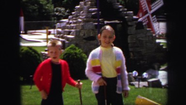 1972: two children playing game on bright day what seems to be brother