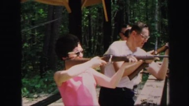 1972: woman and men holding guns at shooting range LYNBROOK, NEW YORK