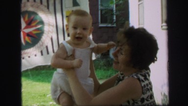 1972: happy redhead baby ginger playing mother outdoor back porch area LYNBROOK