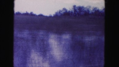 1960: Driving Fast Past Swamp Area Wetland Floods Near Road Florida