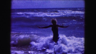 1960: woman frolicking in the waves FLORIDA