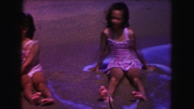1960: mother and daughters relaxing in the waves FLORIDA