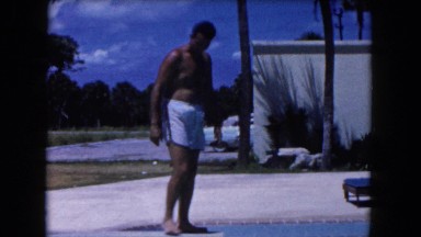 1960: a shirtless man preparing to dive into a swimming pool FLORIDA
