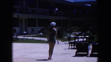 1960: woman lounging by the pool FLORIDA