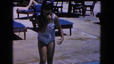 1960: little girl jumping into swimming pool holding nose FLORIDA