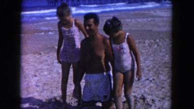 1960: a funny father playing with his two daughters FLORIDA