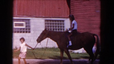 1960: a boy is teaching a girl how to ride a horse FLORIDA
