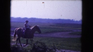 1960: young child riding horse on a dirt road FLORIDA