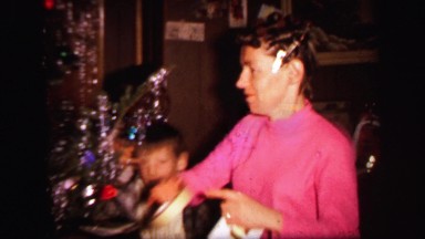1972: christmas tree is seen with child opening presents LYNBROOK, NEW YORK