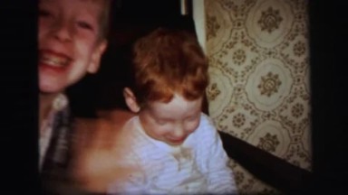 1972: Cute Little Boy in High Chair with Rambunctious Sibling in Lynbrook
