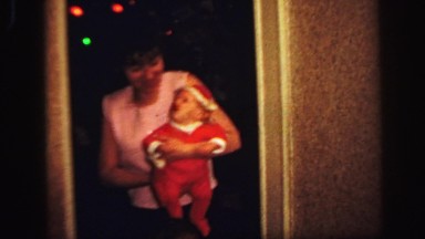 1972: mother is carrying little lad with terrific dress and cap LYNBROOK