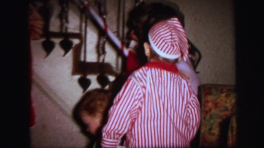 1972: Mother and Sons Hanging Christmas Stockings on Staircase, Lynbrook, New York