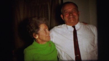 1972: happy old couple stand together with cute smile and waves LYNBROOK