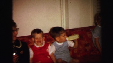 1972: funny and restless kids on the couch with an old woman LYNBROOK, NEW YORK