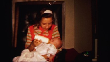 1972: big family visiting for the first time to mom and her newborn baby