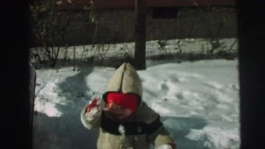 1974: well bundled boy outdoor playing in the snow LYNBROOK, NEW YORK