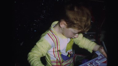 1974: excited kids getting xmas gifts opening for holiday LYNBROOK, NEW YORK