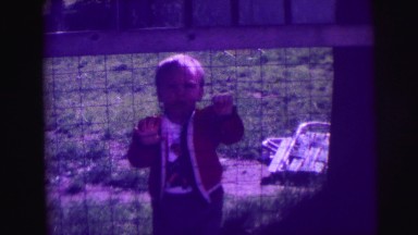 1974: lonely child crying and trying to get over the fence LYNBROOK, NEW YORK