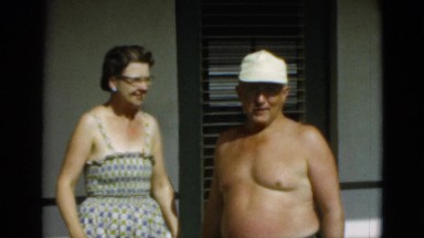 1952: topless man wearing hat posing with wife CAMDEN, NEW JERSEY