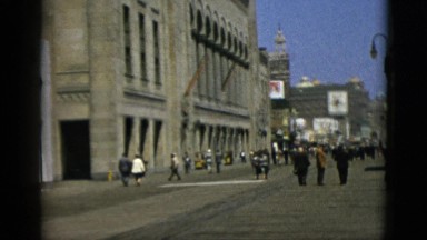 1952: people passing by a wide street with a great old building CAMDEN
