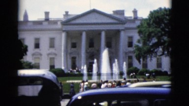 1952: tourists in groups viewing the white house fountains and observing