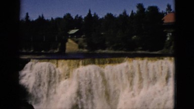 1952: foaming waterfall in forest near lodge on a sunny day. CAMDEN, NEW JERSEY