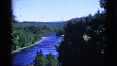 1952: a blue sky above a beautiful winding river as seen through trees CAMDEN