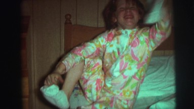 1974: happy child getting ready for bed. CAMDEN, NEW JERSEY