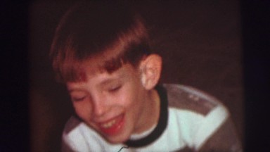 1974: boy playing with airplane toy on christmas morning CAMDEN, NEW JERSEY