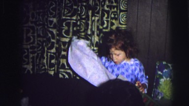 1974: children opening presents on christmas morning with their family