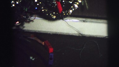 1974: three children receiving gifts such as miniature train for christmas