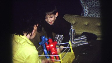1974: two boys on the couch playing a rockem sockem robot toy COLORADO