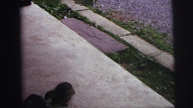 1974: people outdoor on a porch overlooking the water as they feed ducks