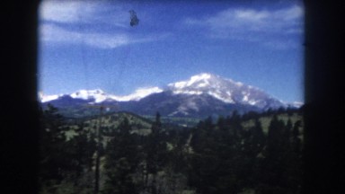 1962: A Snowy Mountain Top Landscape Seen from a Moving Vehicle in Colorado