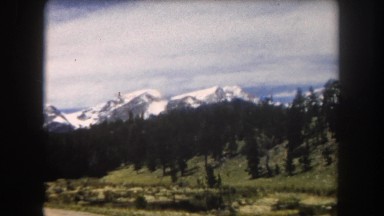 1962: A Beautiful Snow Capped Mountain Ridge as Seen from a Moving Vehicle