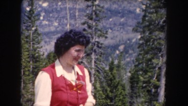 1962: woman in red with camera in the woods pointing out the sights CLARKSDALE