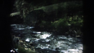 1962: a beautiful river cutting through a mountain as seen from a moving vehicle