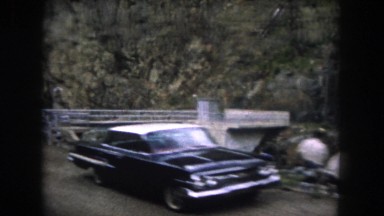 1962: a creek running alongside the road is seen from a moving vehicle MINNESOTA