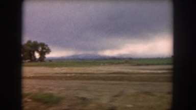 1962: a road drive through the field with the storm CLEVELAND, OHIO