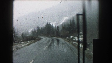 1962: big truck driving on mountain roads slippery conditions and raining