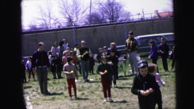 1964: children playing a game in which they walk backwards while balancing eggs