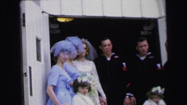 1964: a wedding party with sailors posing for a picture in the doorway CAMDEN