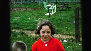 1964: boy and girl playing with a gun in the yard CAMDEN, NEW JERSEY
