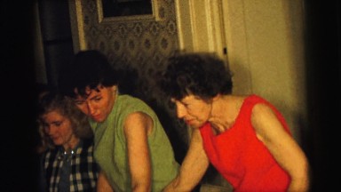 1964: a large group of people seated around the dining room table having dessert