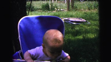 1964: a toddler showing interest to their surroundings in a green area
