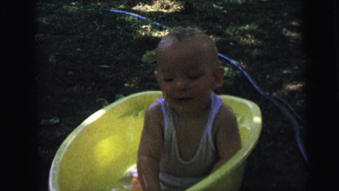 1964: a little kid is playing outdoors in the water CAMDEN, NEW JERSEY