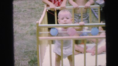 1964: a fun day with the babies in their ground crib outdoors